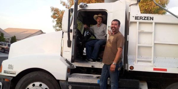 Two men with a white truck.