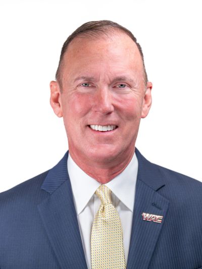 Portrait of a man in a suit with a WAC pin.