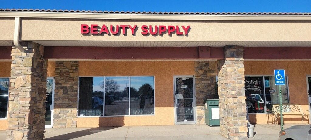 Picture of the exterior of the building, brown building with bold red sign that says "Beauty Supply"