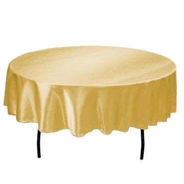 A round table covered with a shiny golden tablecloth.