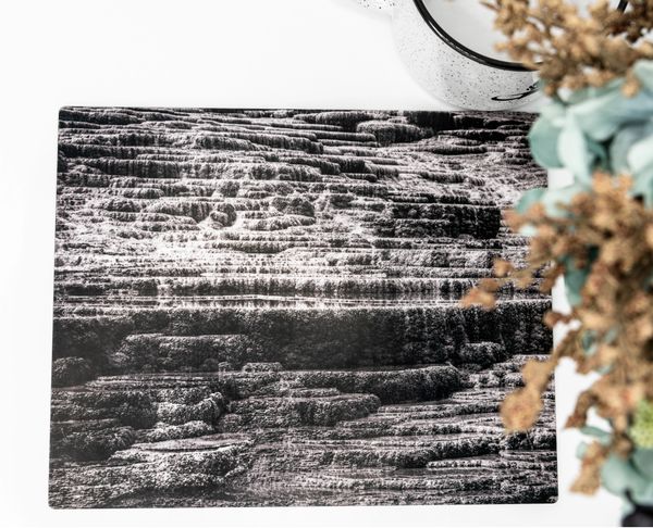 Black and white flat lay of Mammoth Hot Springs Yellowstone National Park with flowers and cup.