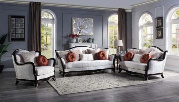Elegant living room with vintage sofa set and large windows.