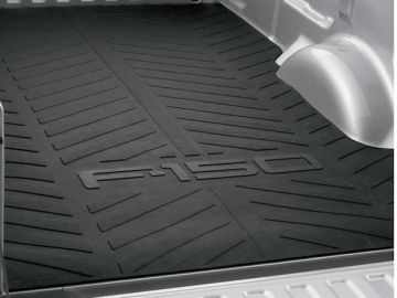 Black bed liner with 'GMC' logo inside a vehicle bed.