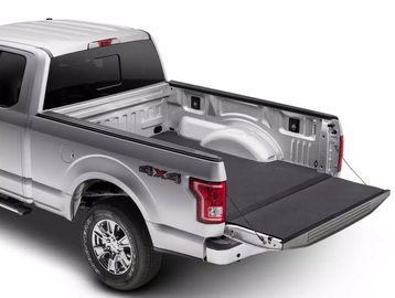 Silver pickup truck with an open tailgate and bed liner.