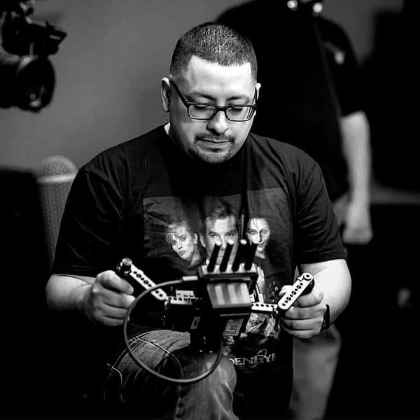 Man controlling a drone or remote device indoors.