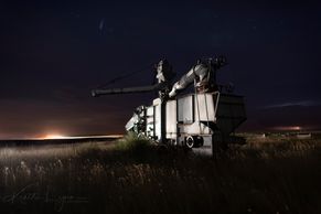 Abandoned thrasher machine as modern day combines harvest the field at night