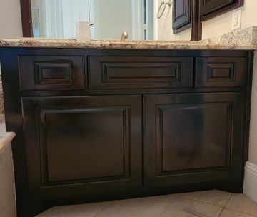 Glossy, professionally refinished cabinets in kitchen or bathroom.