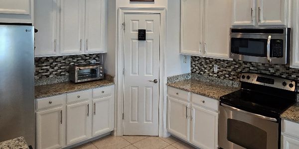 Bonita Springs Kitchen Cabinet Refinish by  Vassett Painting.