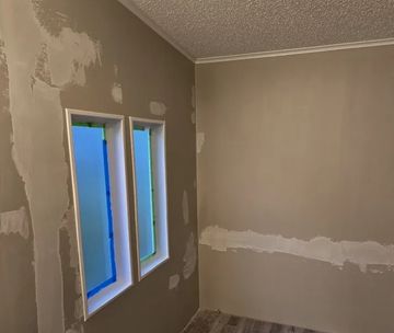 Wall showing smoothly patched areas ready for paint.