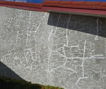 Stucco wall with repaired and sealed cracks before painting.