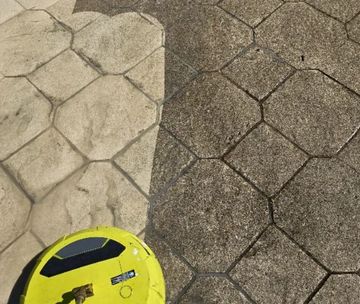 Driveway power washing comparison, cleaned vs. uncleaned side.