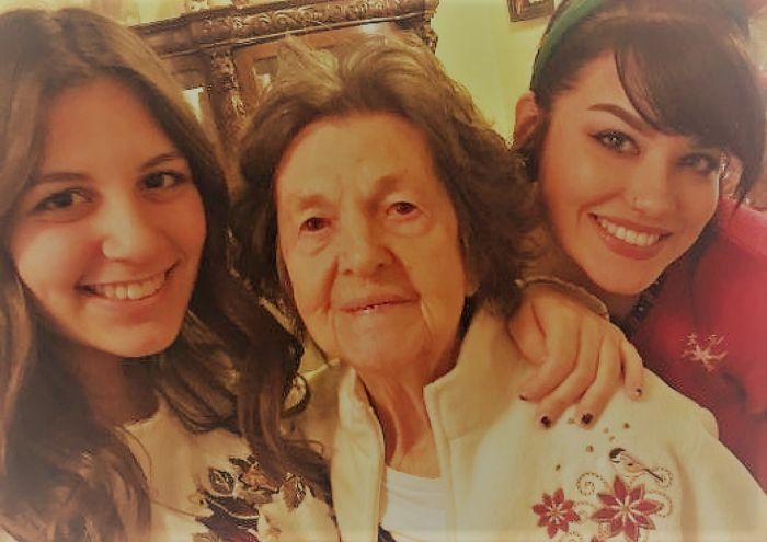 Grandma and adult granddaughters smiling for picture