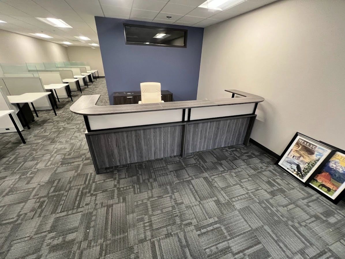 Newport gray 6x12 reception desk with frosted plexiglass with knoll cubicles in the background