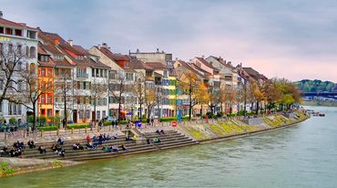 Europeans enjoying sunset by the river.