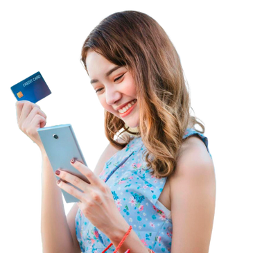 A smiling woman holding a credit card and smartphone, appearing excited.