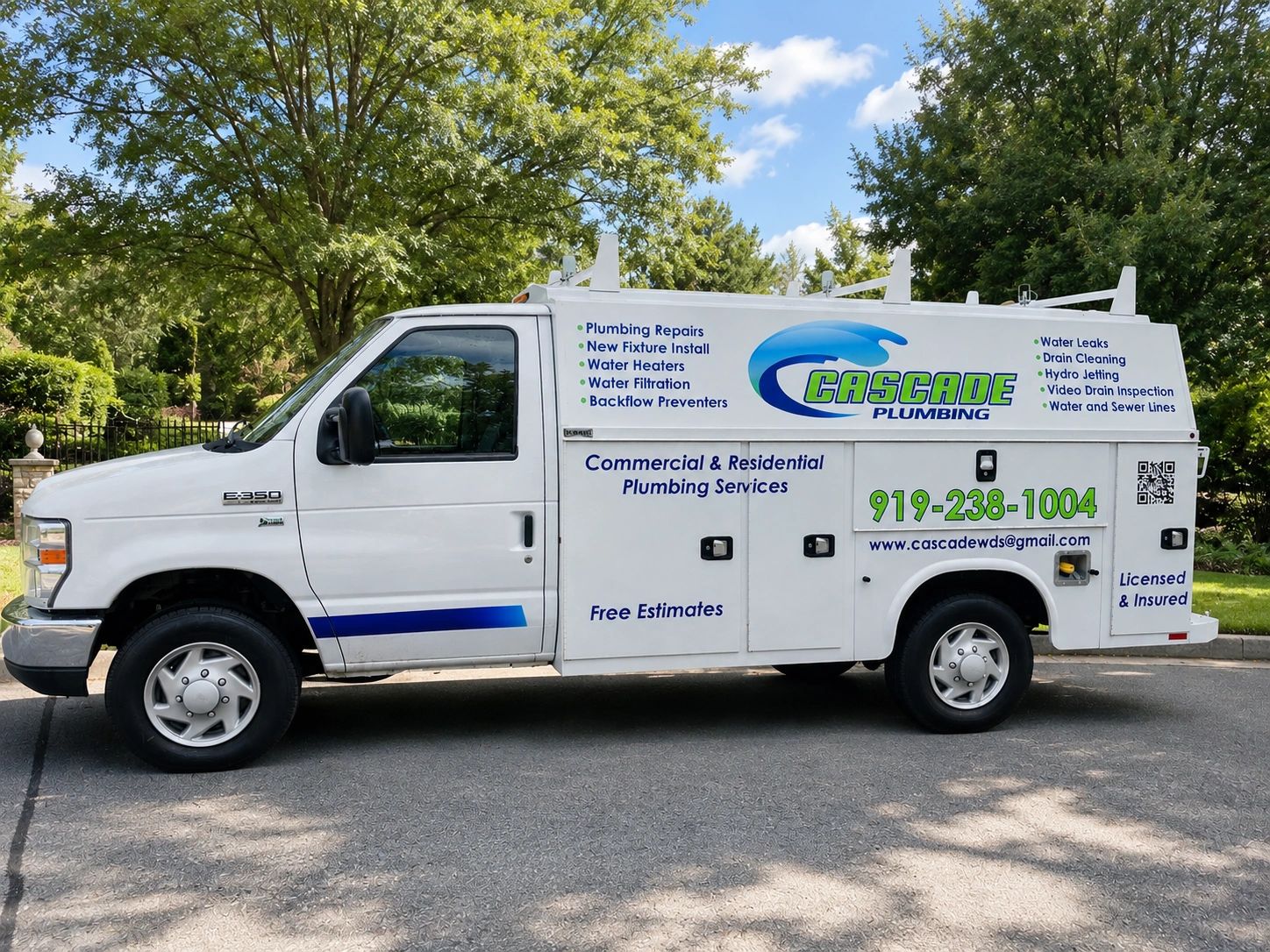 White service truck for Cascade Plumbing with contact info and service list.