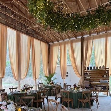 Soaring ceiling draping with greenery ceiling installation.