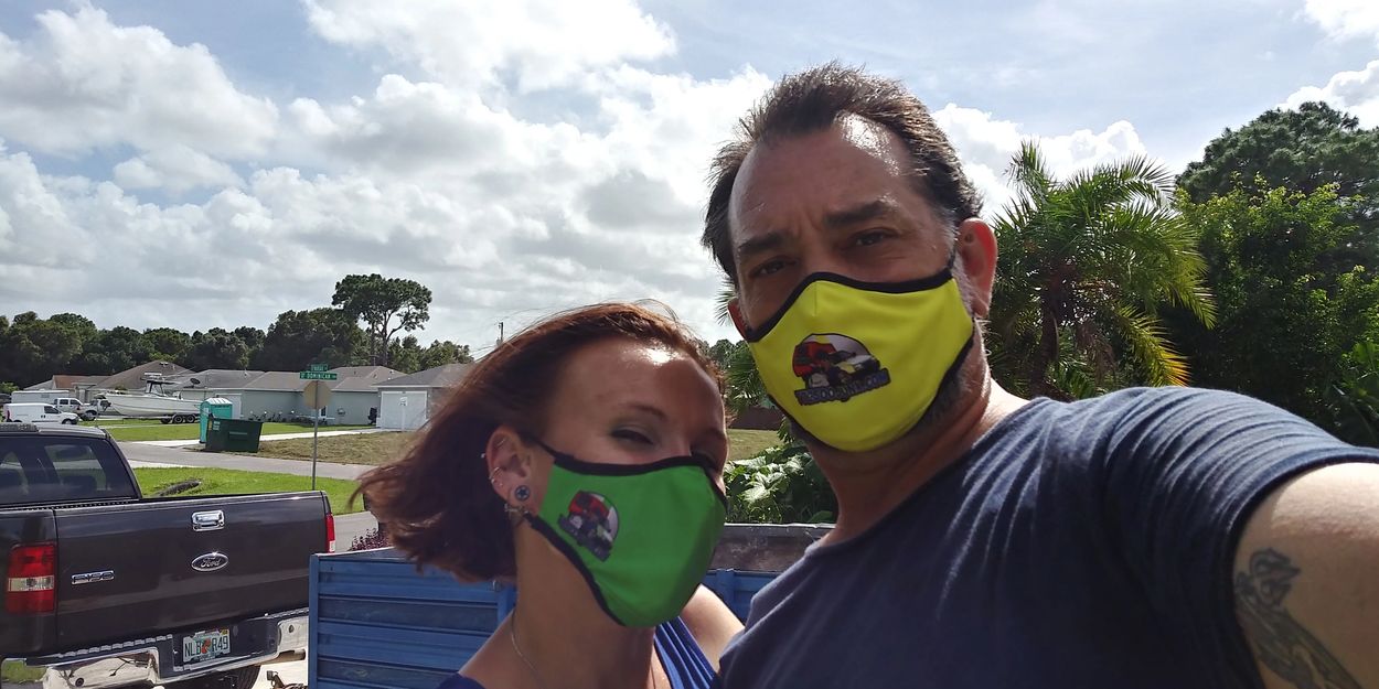 Ashley & James of A & J's Removal Services, wearing their safety masks with our new company logo. 