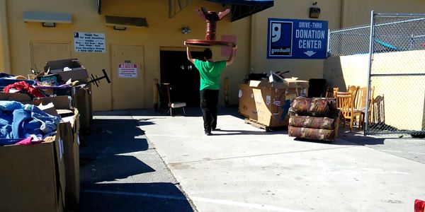 James from A & J's Removal Services, is dropping off a table for donation.