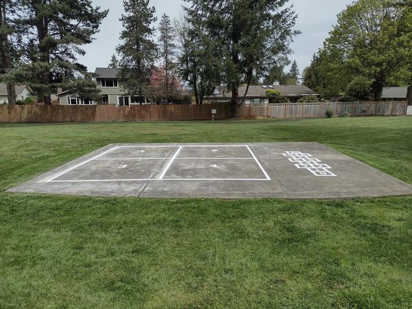 Four Square and hopscotch games painted on concert pad at Allen Park.