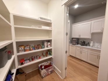 Organized pantry shelves with snacks and drinks.