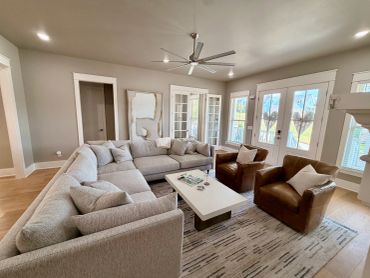 Cozy living room with sectional sofa and leather chairs.