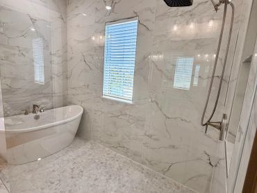 Modern bathroom with bathtub and rain shower.