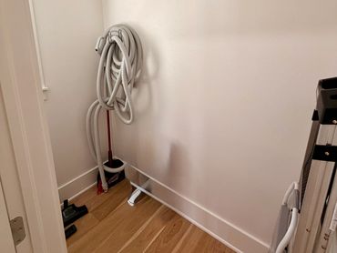 Vacuum cleaner and ladder in a small room.