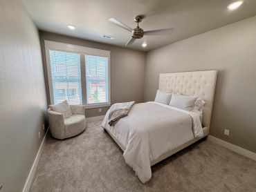 Minimalist bedroom with beige walls and furniture.