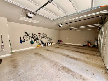 Spacious garage with bicycles mounted on the wall.