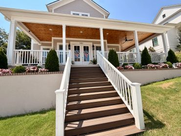 Front porch with stairs and patriotic door decorations.