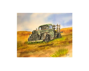 An old, green pick-up truck in its final resting place