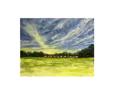 The sun shining through the clouds over a field along the backroads in Missouri