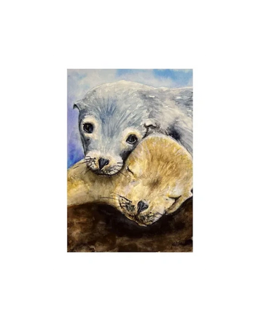 Two sealions resting on their mother as one sleeps and the other looks over him