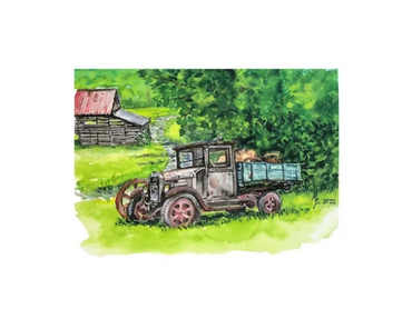 An antique, green truck with a wood bed is parked up the hill from an old barn