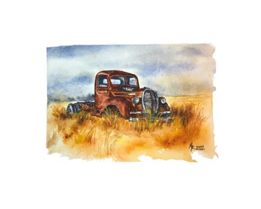 A very old, rusted truck sits in a field in the fall