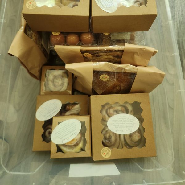 Assortment of packaged baked goods in a clear plastic container.