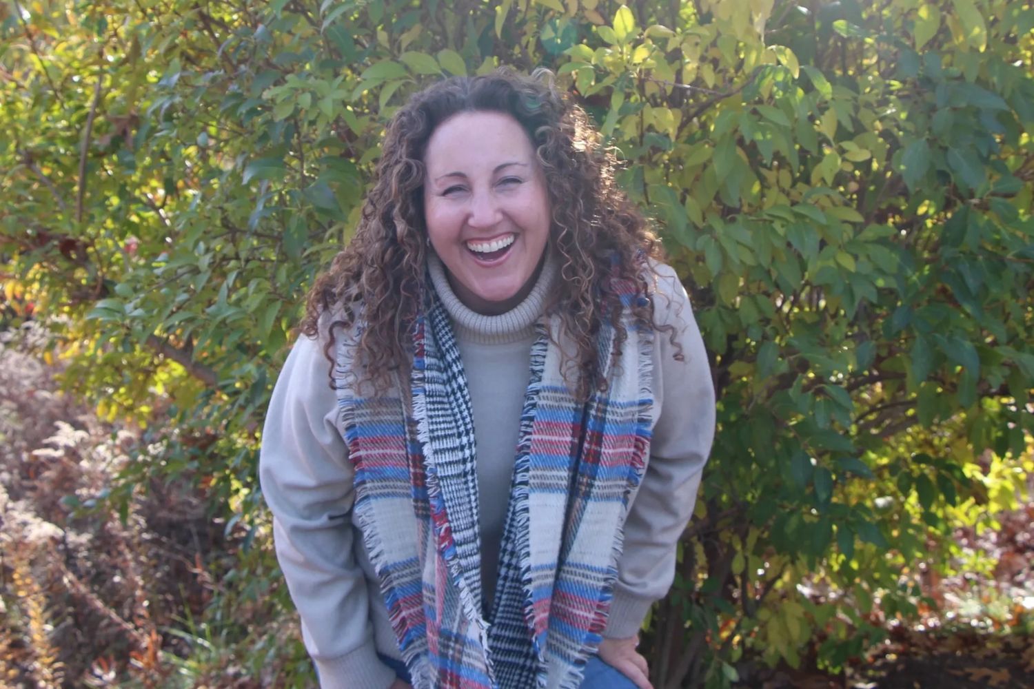 headshot of jenny near a bush