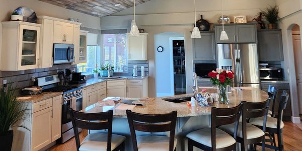 Modern kitchen with large island and bar stools.