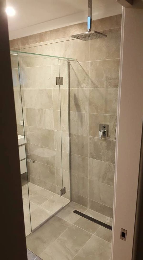 infinity glass open shower with perfect tiling
