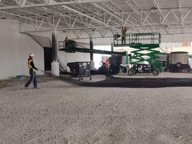 bird netting being stretched out before being installed in the canopy above