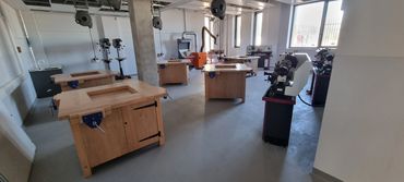 Workshop with wooden tables and machines.
