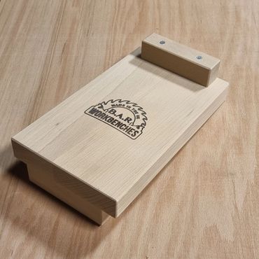 A wooden tool with B.A.R. Workbenches logo on a wooden surface.