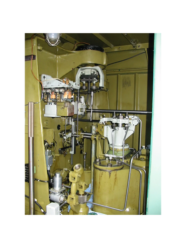 Interior of a vintage mechanical or electrical control panel with various components.