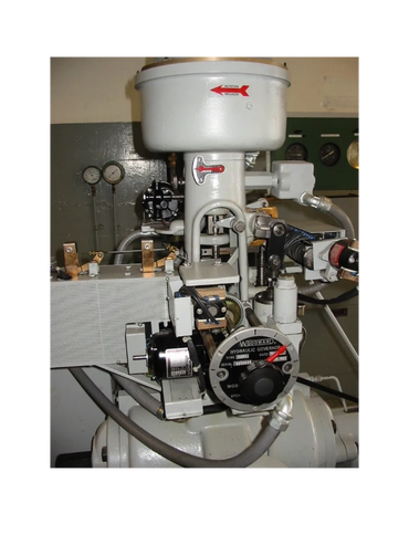 Close-up of a Woodward hydraulic governor mechanical control system.