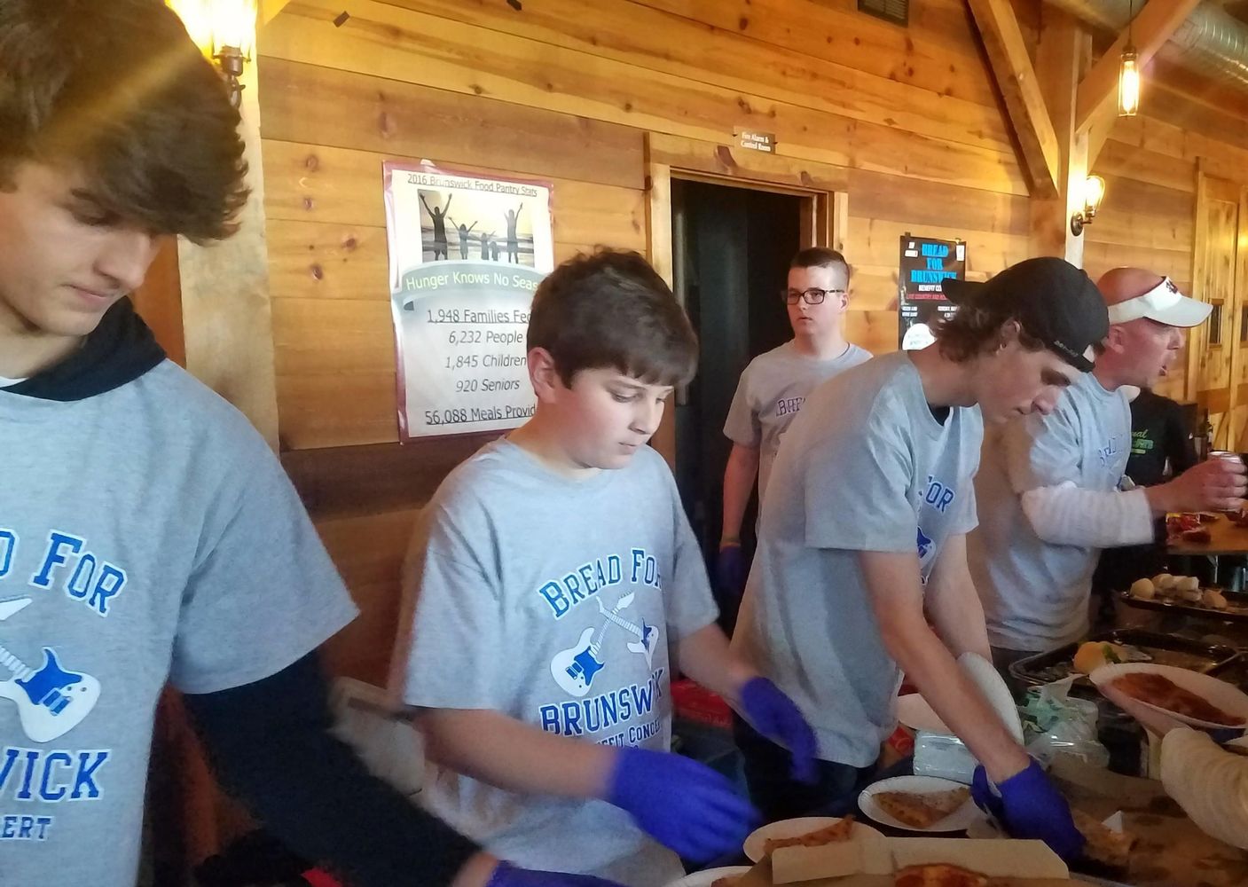 Youth volunteers serve food at annual fundraiser.