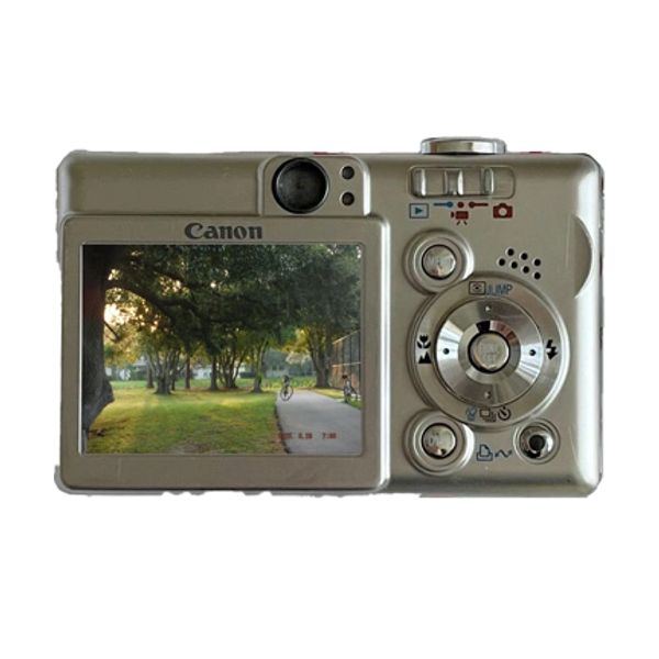 Back view of a Canon digital camera displaying a park scene on its screen.