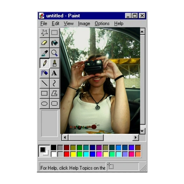 Person taking photo inside a vintage MS Paint window frame.