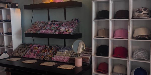 A store display with hats and folded fabrics.