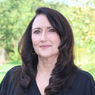 Portrait of a middle-aged woman with dark hair.